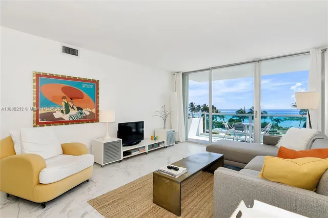 a living room with furniture wooden floor and a flat screen tv