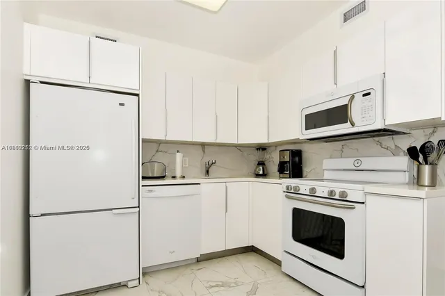 a white refrigerator freezer sitting in a kitchen