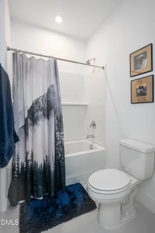 a spacious bedroom with a bed and a couch