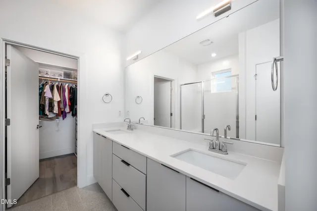 a bathroom with double sink and a mirror