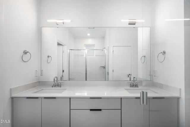 a bathroom with a sink mirror and vanity