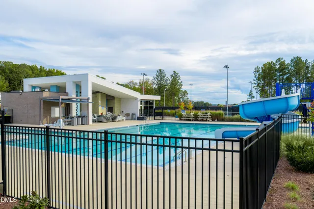 a view of a street with houses in the background