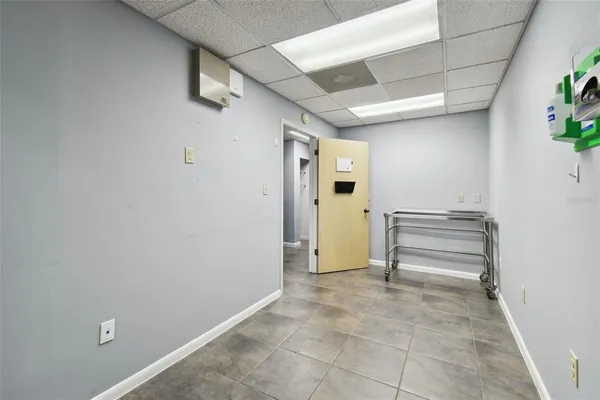 a view of a hallway with wooden shelves