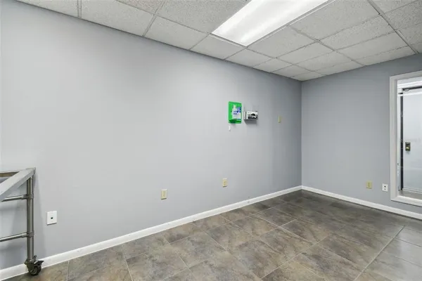 a view of a hallway with wooden floor and a bathroom