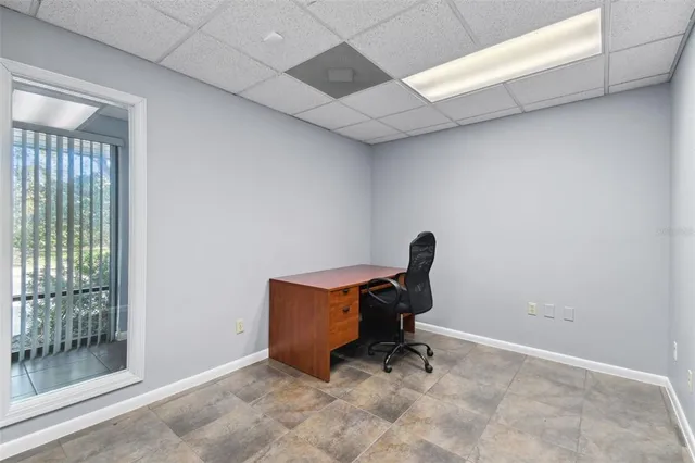 a view of workspace with a chair and wooden floor