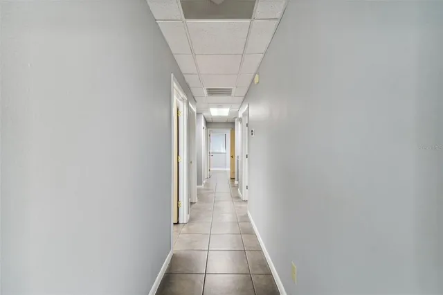 a view of a hallway with wooden floor and door