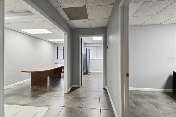 a view of a hallway with wooden shelves