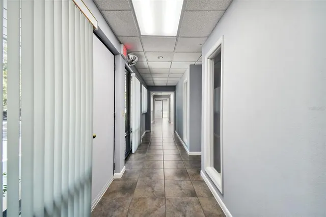 a view of workspace with furniture and floor to ceiling window