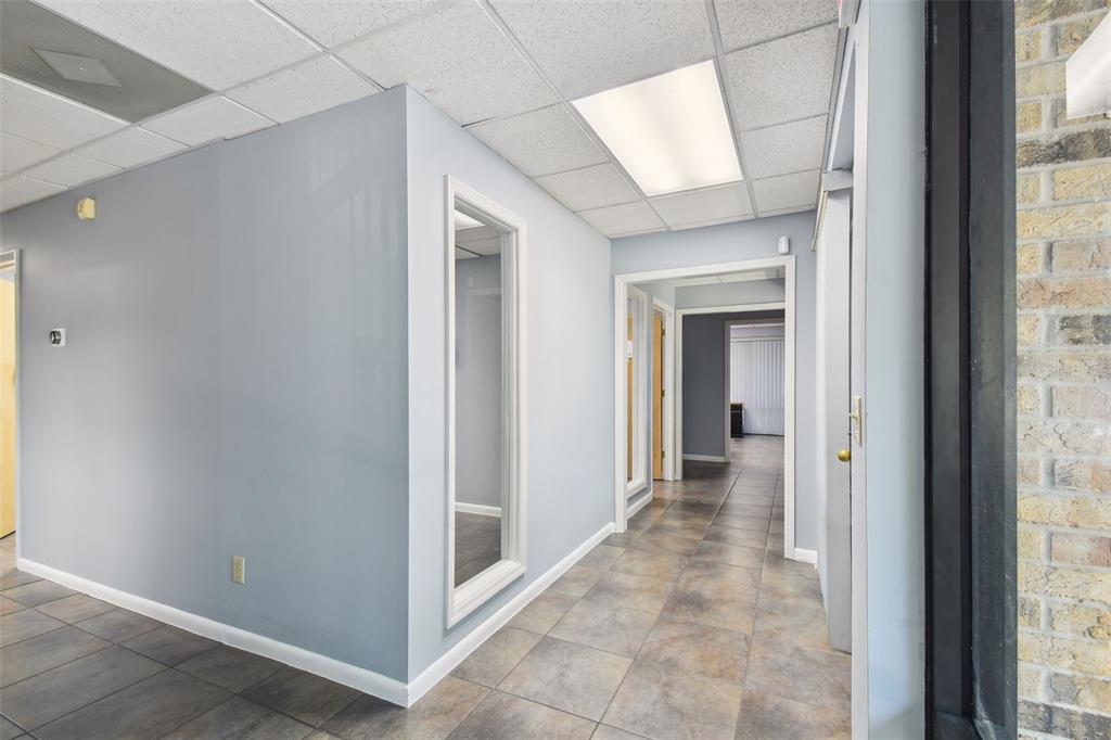 701 Enterprise Road East, Unit 100 Safety Harbor, FL 34695 - Photo 33 of 96 a view of a hallway with wooden floor and a bathroom