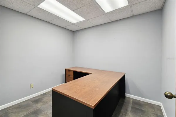 a bathroom with a granite countertop sink a toilet and a mirror