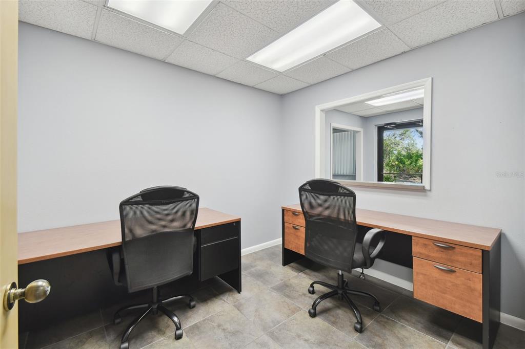 701 Enterprise Road East, Unit 100 Safety Harbor, FL 34695 - Photo 37 of 96 a view of workspace with a chair and wooden floor