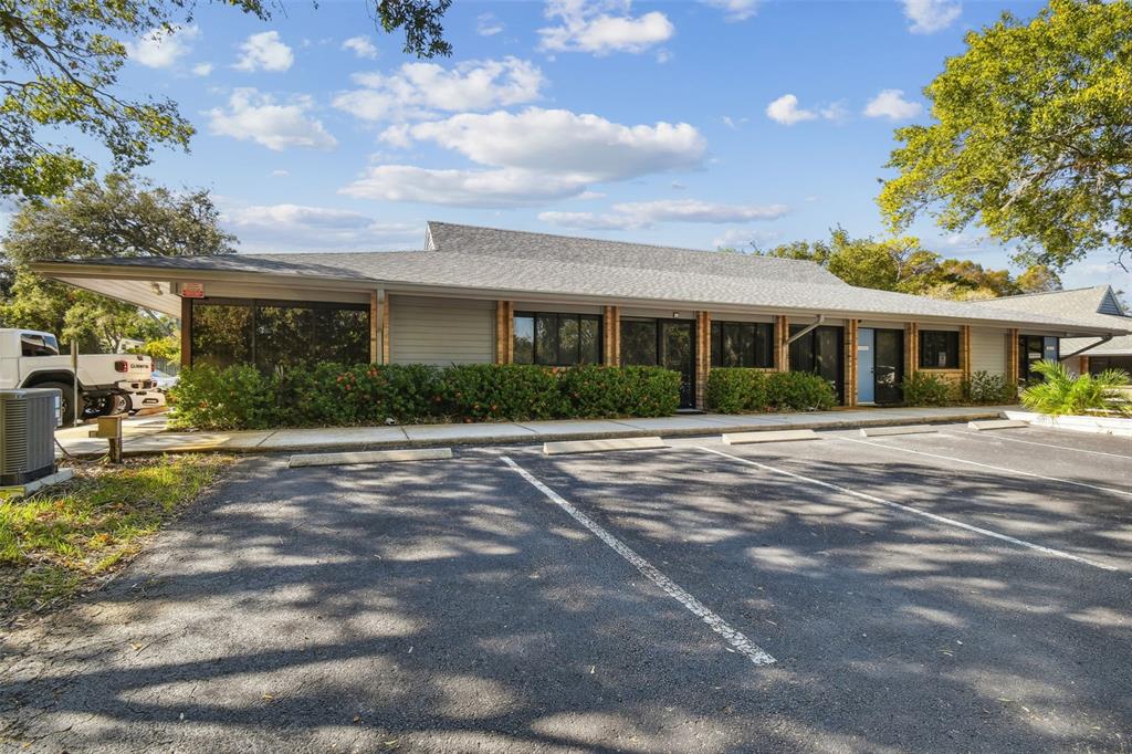 701 Enterprise Road East, Unit 100 Safety Harbor, FL 34695 - Photo 4 of 96 a front view of a house with a yard