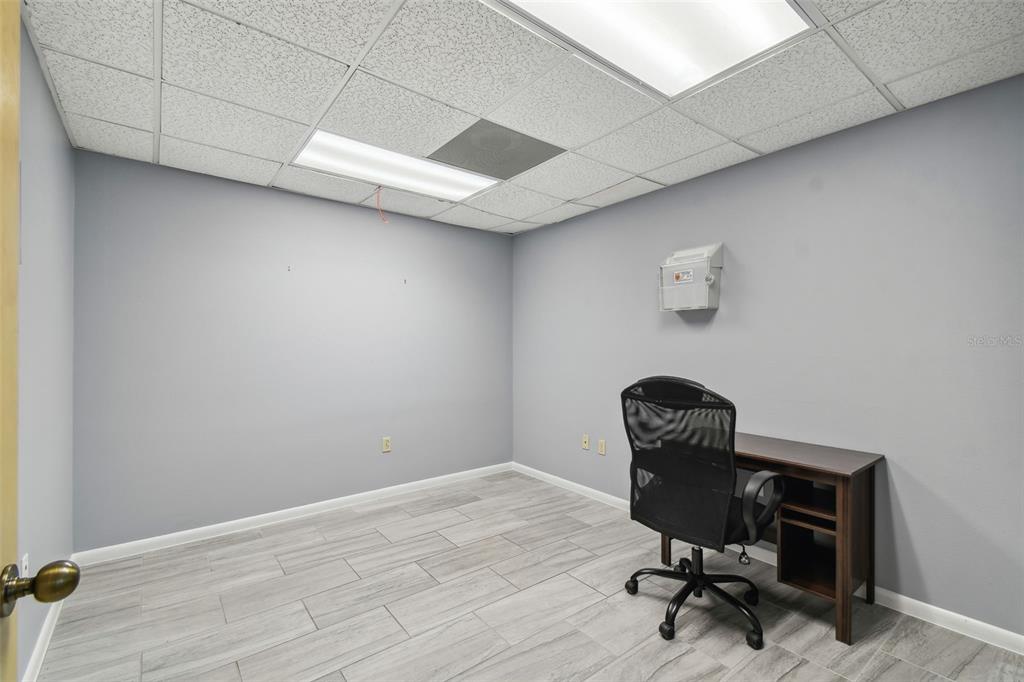 701 Enterprise Road East, Unit 100 Safety Harbor, FL 34695 - Photo 41 of 96 a view of workspace with chair and wooden floor