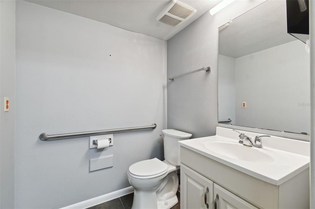 701 Enterprise Road East, Unit 100 Safety Harbor, FL 34695 - Photo 44 of 96 a bathroom with a sink toilet and a mirror