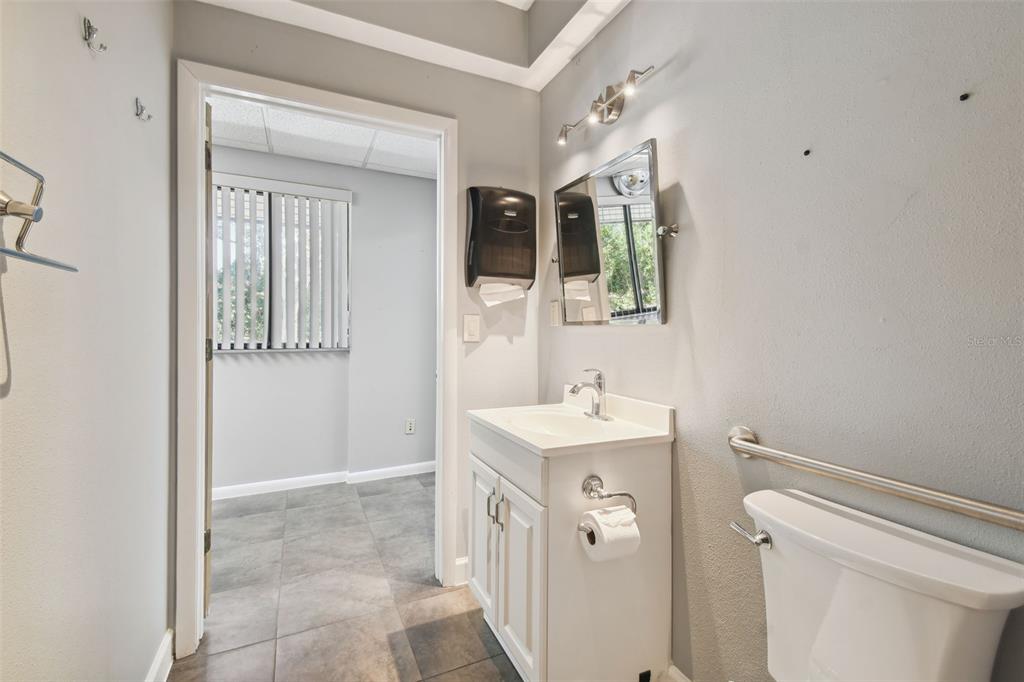 701 Enterprise Road East, Unit 100 Safety Harbor, FL 34695 - Photo 49 of 96 a bathroom with a sink a toilet and shower