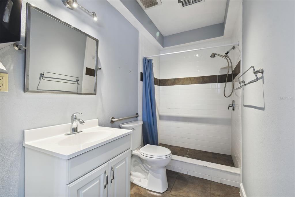 701 Enterprise Road East, Unit 100 Safety Harbor, FL 34695 - Photo 50 of 96 a bathroom with a sink toilet and shower