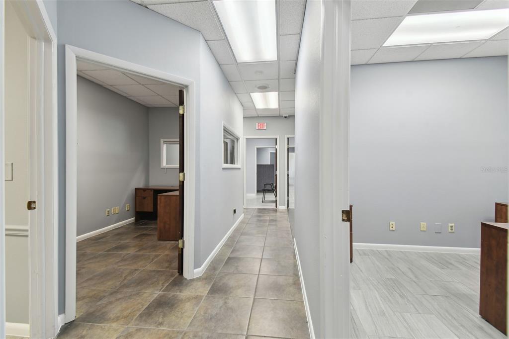 701 Enterprise Road East, Unit 100 Safety Harbor, FL 34695 - Photo 63 of 96 a view of a hallway with wooden floor and a living room