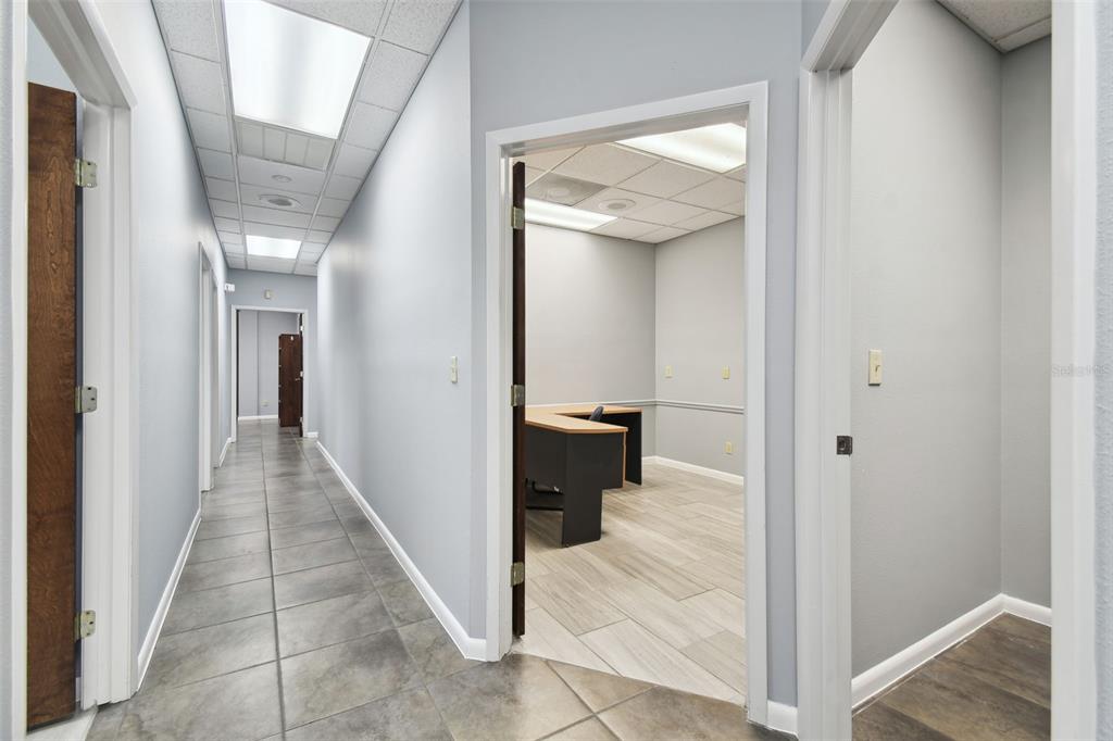 701 Enterprise Road East, Unit 100 Safety Harbor, FL 34695 - Photo 64 of 96 a view of a hallway with wooden floor and staircase