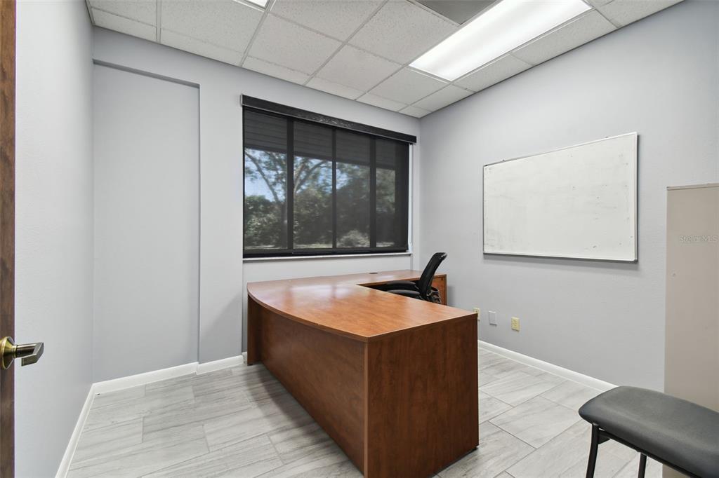 701 Enterprise Road East, Unit 100 Safety Harbor, FL 34695 - Photo 66 of 96 a room with wooden floor and a window