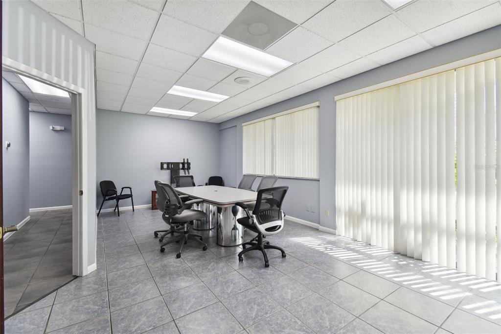 701 Enterprise Road East, Unit 100 Safety Harbor, FL 34695 - Photo 76 of 96 a view of a dining room with furniture and a window