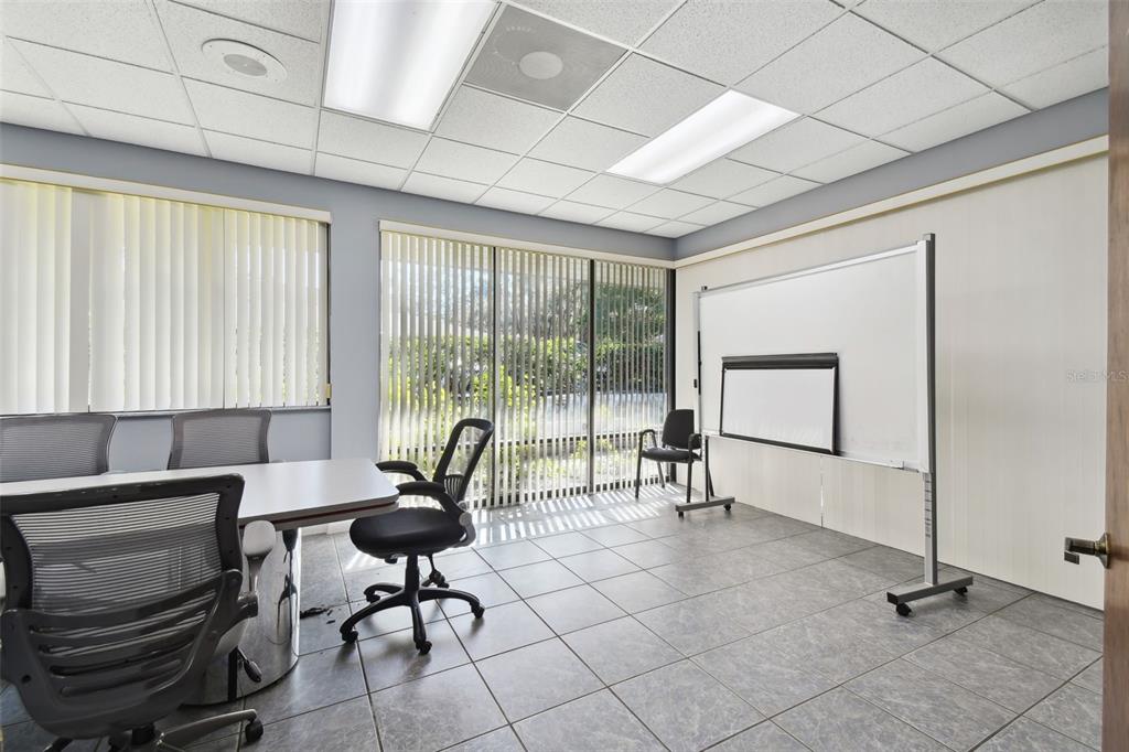 701 Enterprise Road East, Unit 100 Safety Harbor, FL 34695 - Photo 77 of 96 a living room with furniture and a floor to ceiling window