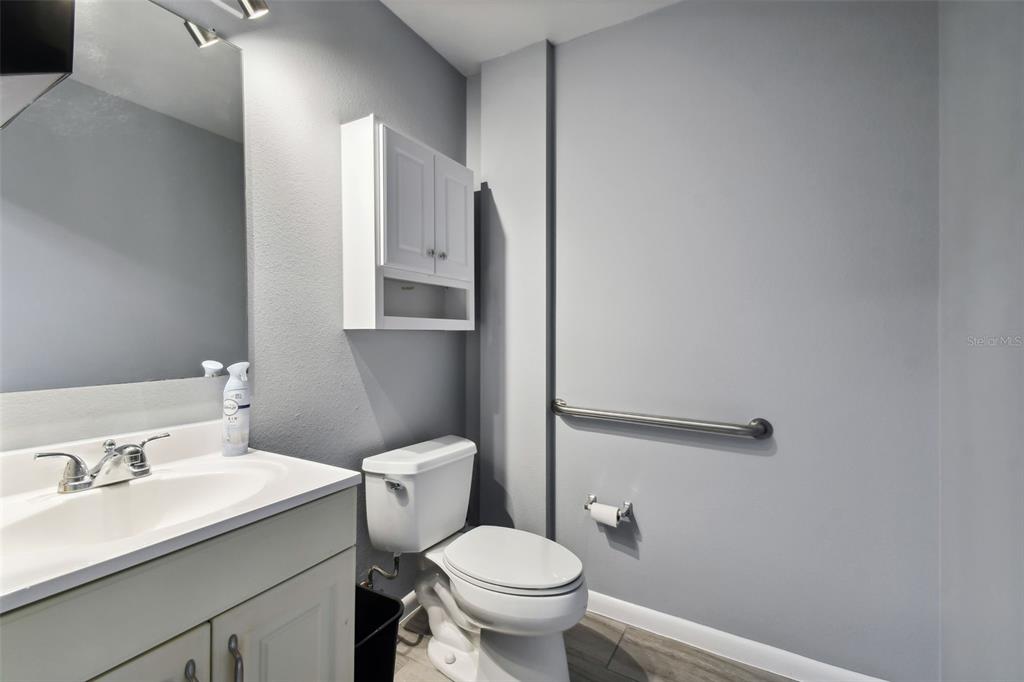701 Enterprise Road East, Unit 100 Safety Harbor, FL 34695 - Photo 84 of 96 a bathroom with a toilet sink and mirror