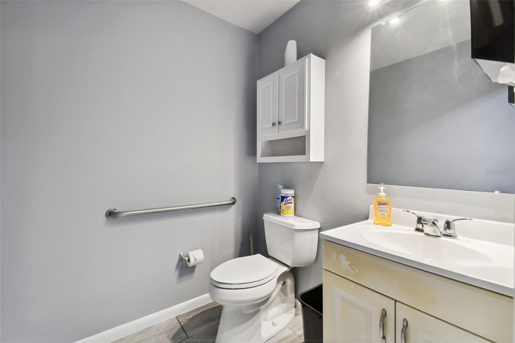 701 Enterprise Road East, Unit 100 Safety Harbor, FL 34695 - Photo 85 of 96 a bathroom with a sink toilet and a mirror
