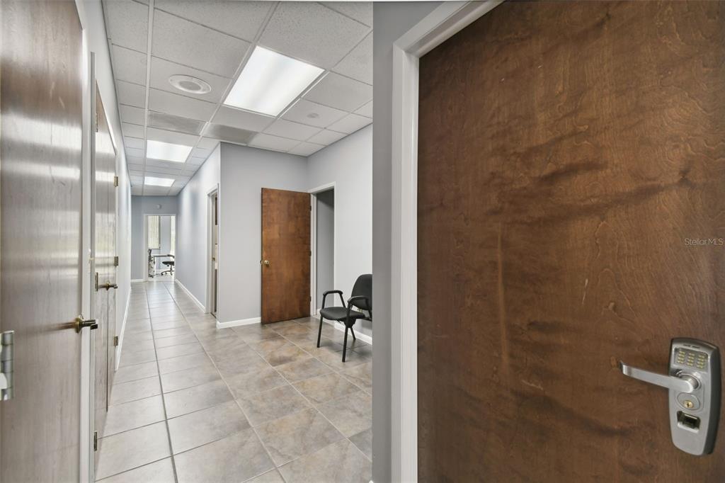 701 Enterprise Road East, Unit 100 Safety Harbor, FL 34695 - Photo 88 of 96 a bathroom with a glass door shower a mirror and a sink