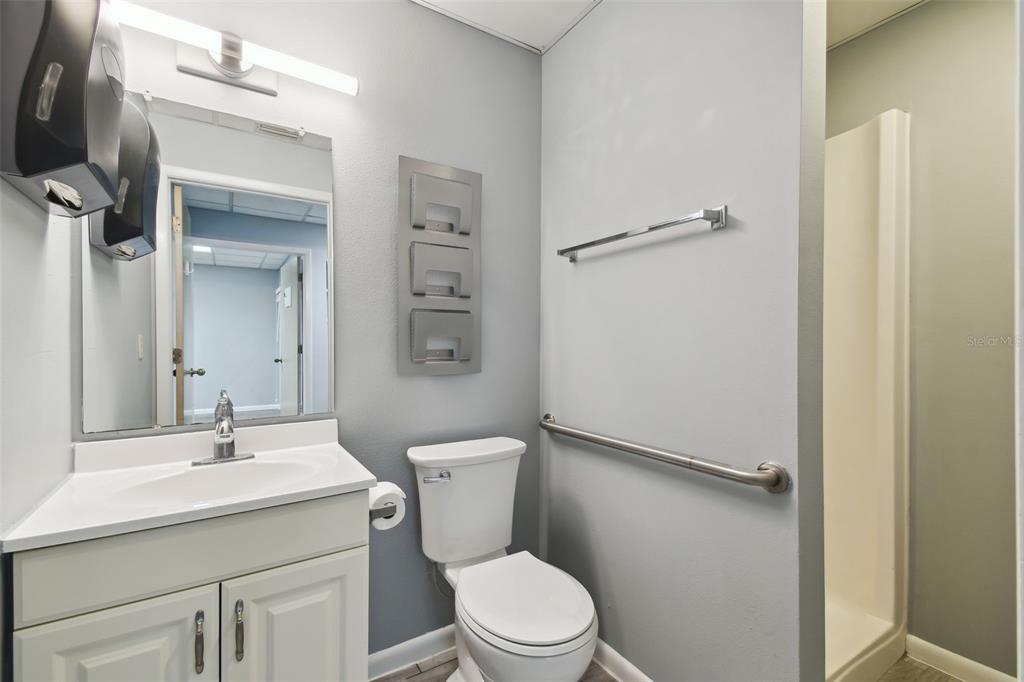 701 Enterprise Road East, Unit 100 Safety Harbor, FL 34695 - Photo 9 of 96 a bathroom with a sink a toilet and shower