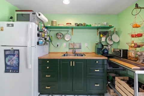 a kitchen with a refrigerator and a stove