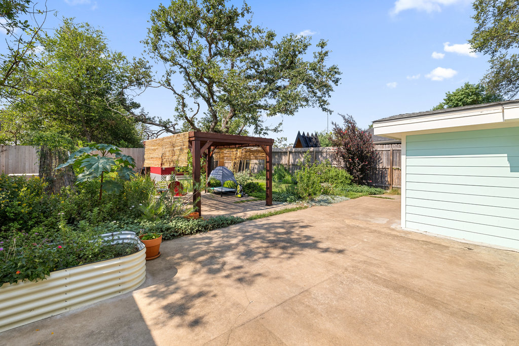 4607 Kitty Avenue Austin, TX 78721 - Photo 25 of 33 a view of a house with a yard and potted plants