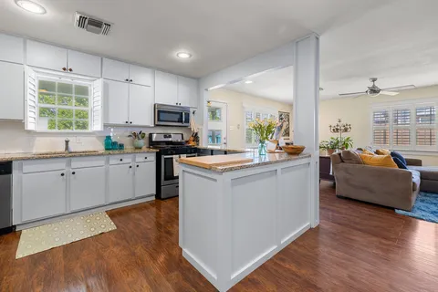a kitchen with counter top space a sink appliances and cabinets