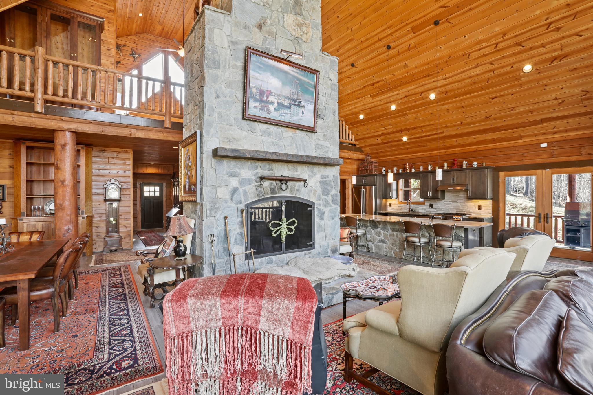3444 Calmes Neck Lane Boyce, VA 22620 - Photo 17 of 66 a living room with furniture a fireplace and a table
