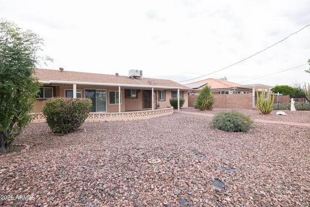 a view of a house with a backyard