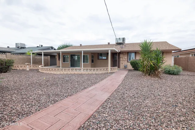 a view of a house with a backyard