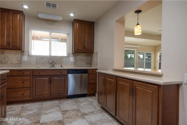 a kitchen with granite countertop a sink and a window