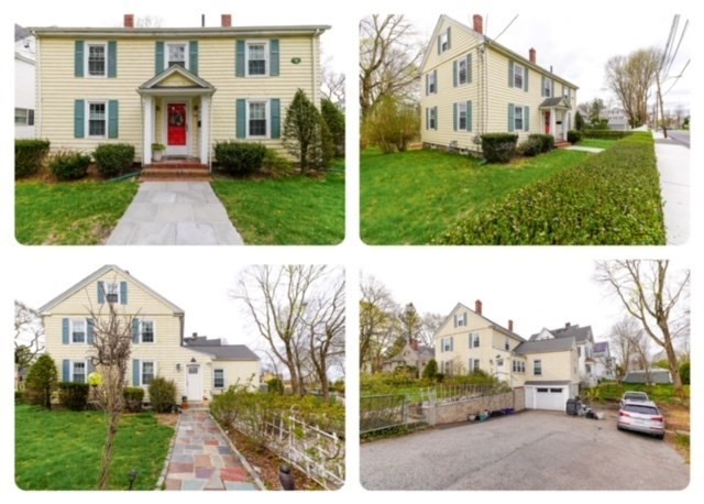 a view of a white house with a big yard plants and large trees