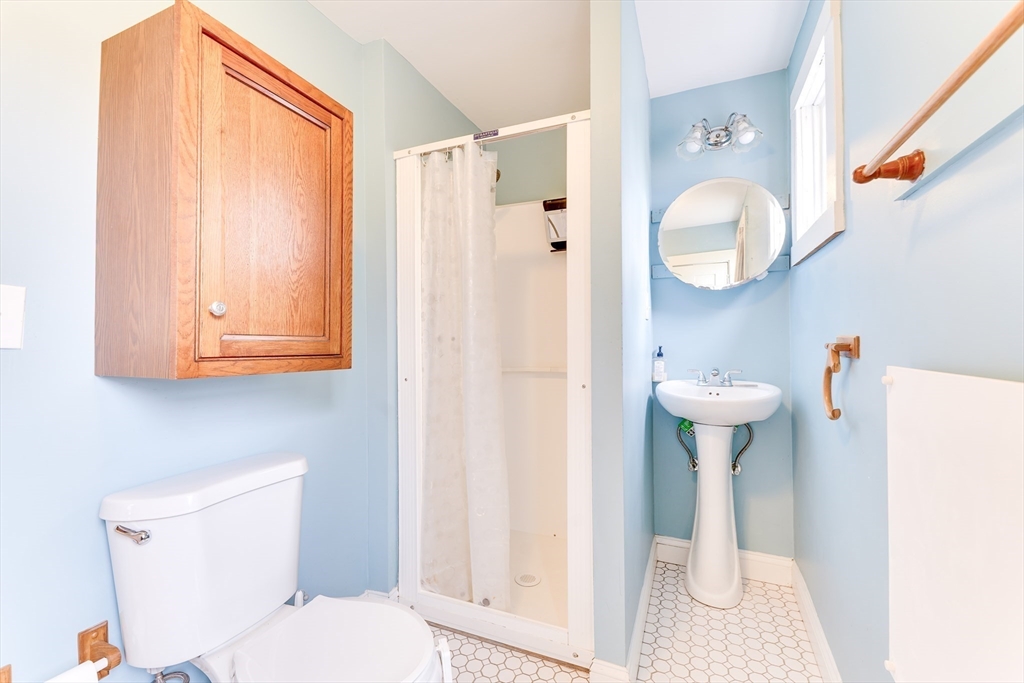 506 Washington Street Dedham, MA 02026 - Photo 13 of 28 a bathroom with a sink a toilet and shower