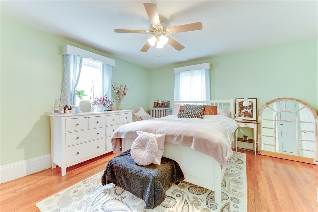 506 Washington Street Dedham, MA 02026 - Photo 18 of 28 a bedroom with a bed and wooden floor