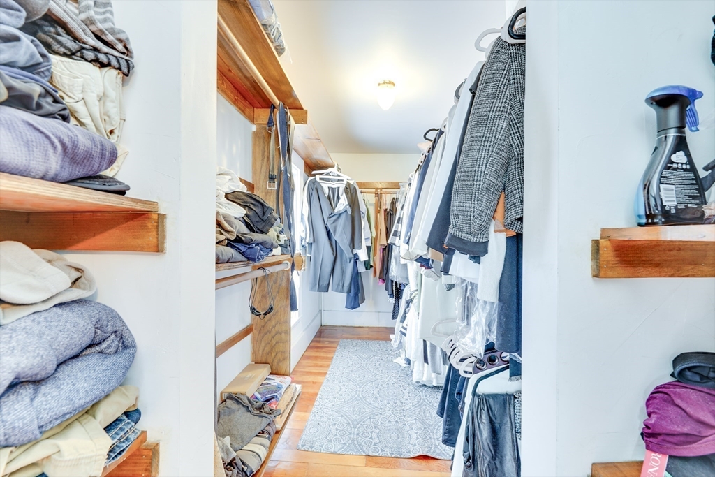 506 Washington Street Dedham, MA 02026 - Photo 22 of 28 a view of walk in closet with clothes and shoes