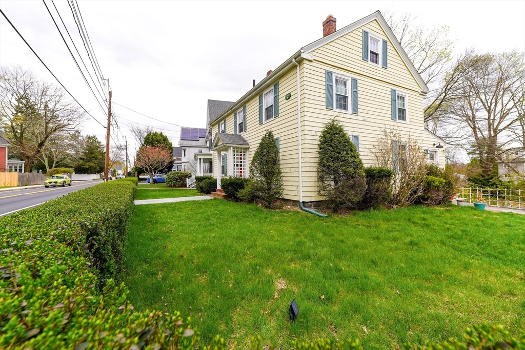 506 Washington Street Dedham, MA 02026 - Photo 25 of 28 a front view of house with a garden