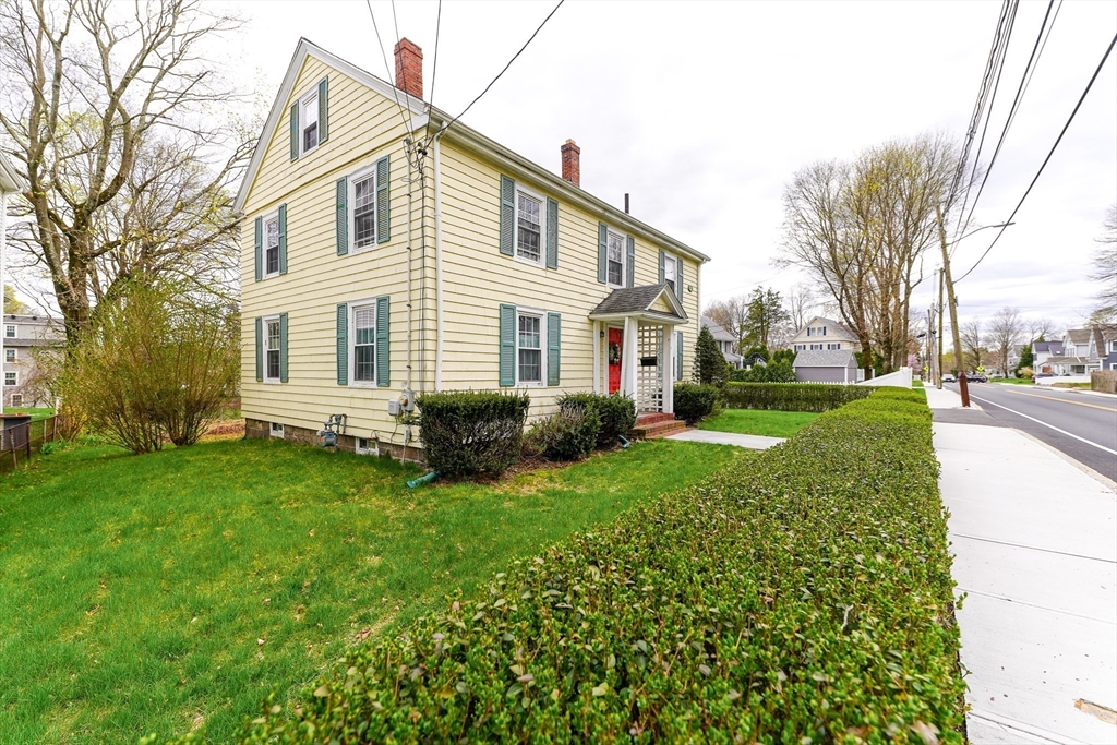 506 Washington Street Dedham, MA 02026 - Photo 3 of 28 a front view of a house with a yard