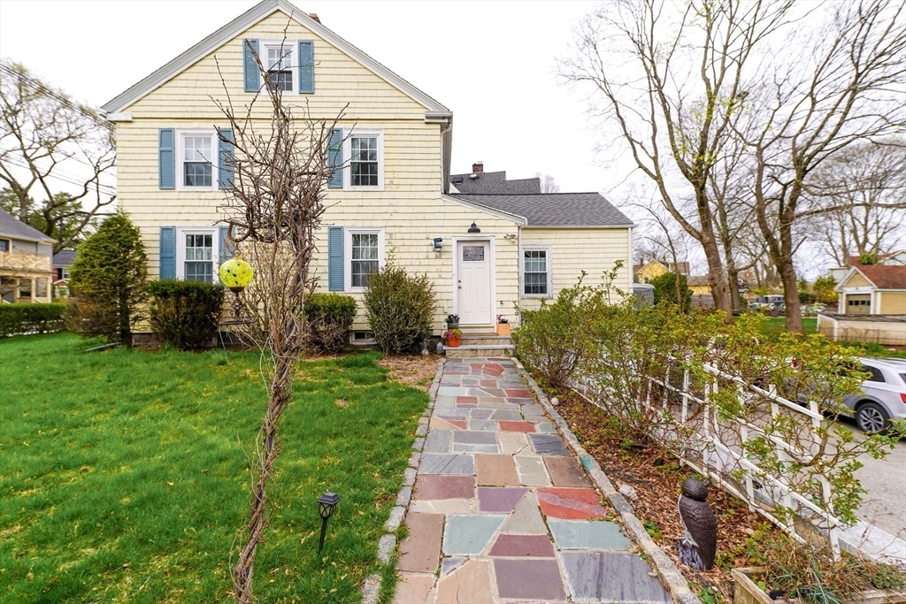 506 Washington Street Dedham, MA 02026 - Photo 4 of 28 a front view of a house with a yard
