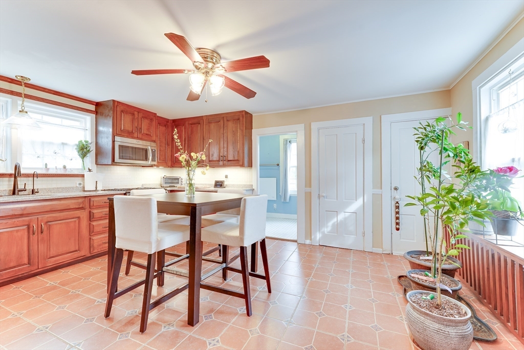 506 Washington Street Dedham, MA 02026 - Photo 6 of 28 a kitchen with stainless steel appliances a table and chairs in it