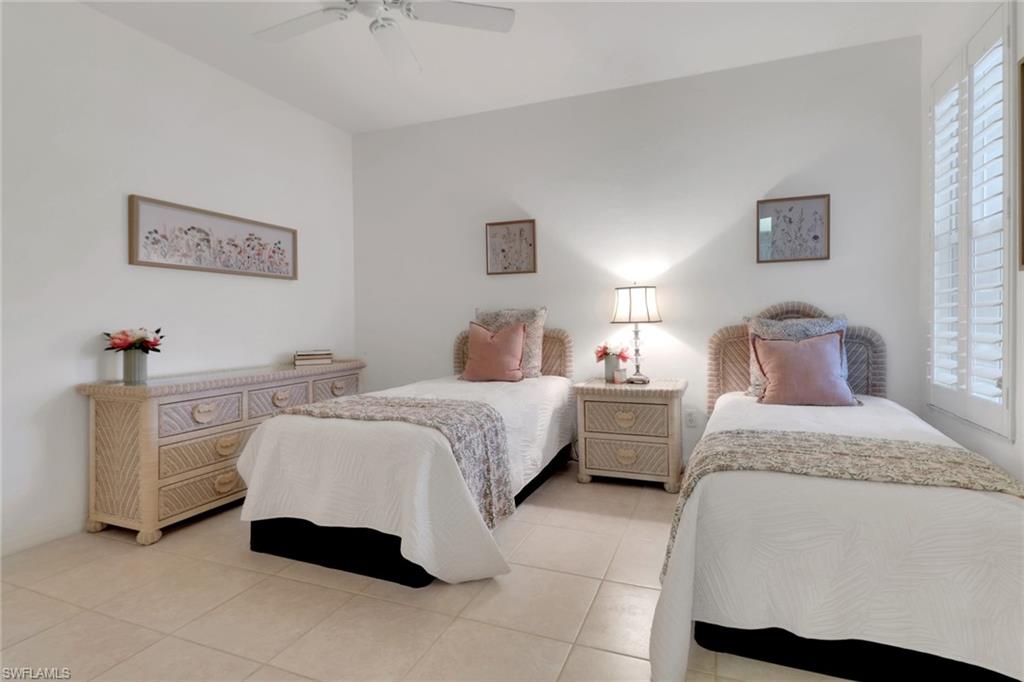 23790 Clear Spring Court, Unit 1603 Estero, FL 34135 - Photo 16 of 39 a spacious bedroom with a bed and a lamp