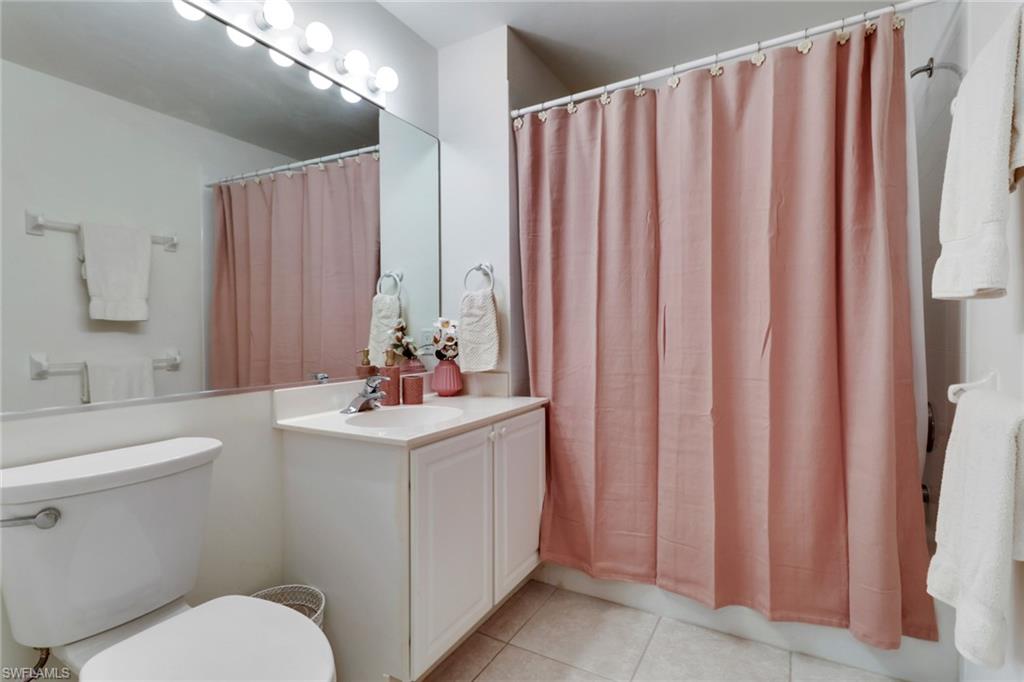 23790 Clear Spring Court, Unit 1603 Estero, FL 34135 - Photo 18 of 39 a bathroom with a sink a toilet and shower curtain
