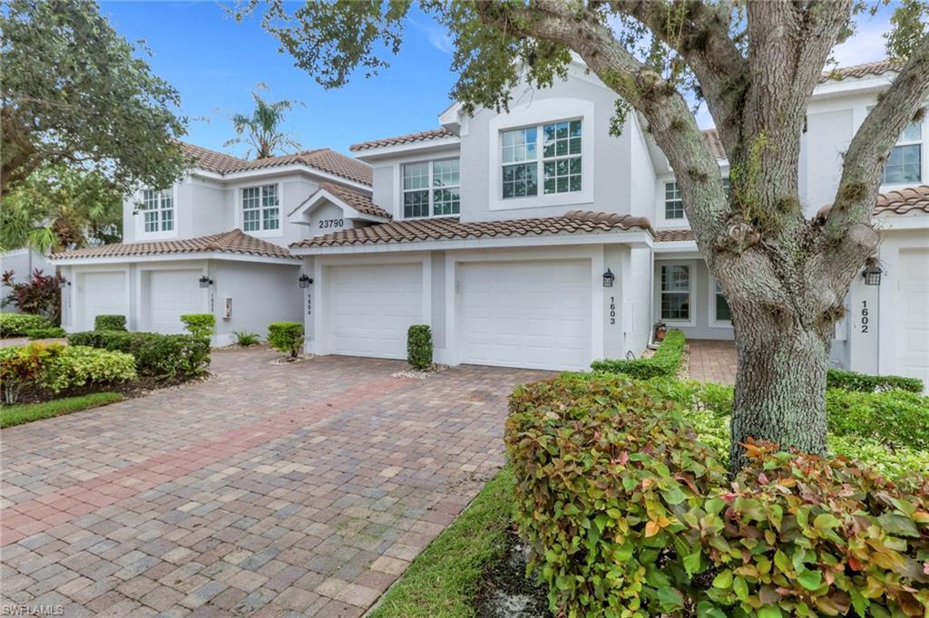 23790 Clear Spring Court, Unit 1603 Estero, FL 34135 - Photo 24 of 39 a front view of a house with a garden