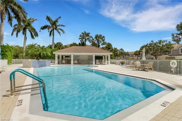 an aerial view of a house with outdoor space and trees all around