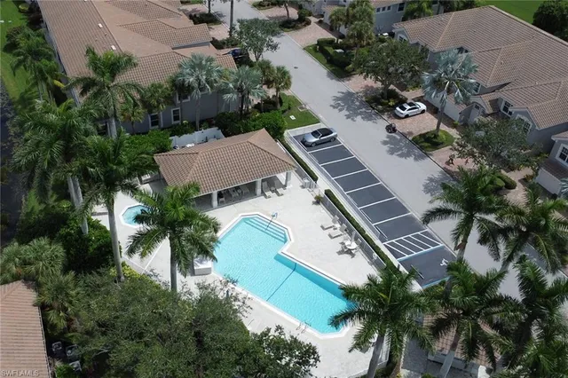 an aerial view of a house with a garden and swimming pool