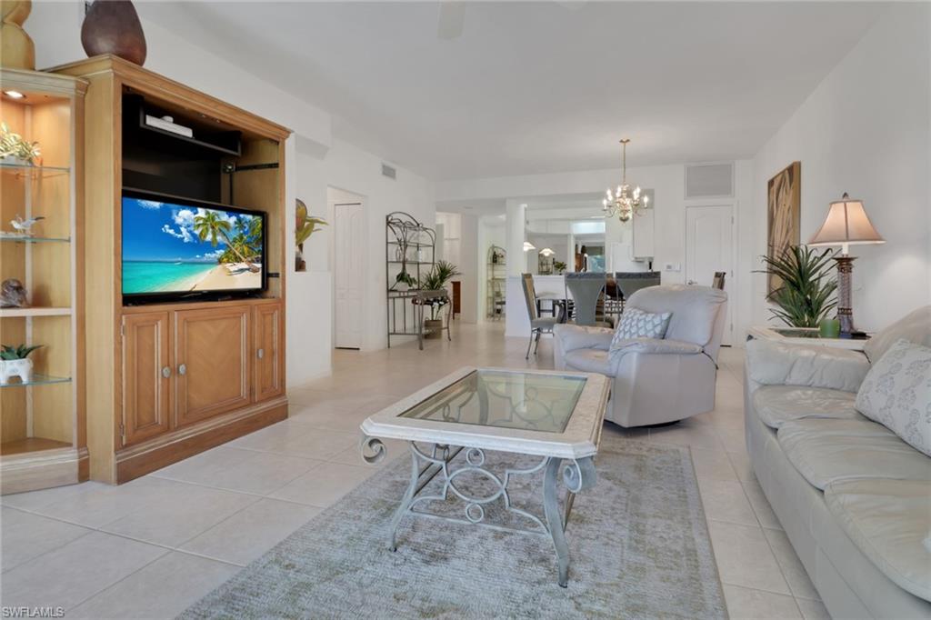 23790 Clear Spring Court, Unit 1603 Estero, FL 34135 - Photo 4 of 39 a living room with furniture and a flat screen tv